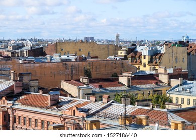 Roofs of St. Petersburg on a Sunny day against the blue sky and clouds