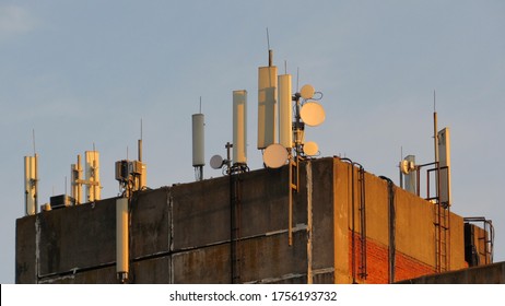 Rooftop Cell Tower Antennas At Sunrise