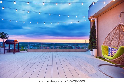 rooftop deck patio area with hanging chair on a sunset - Shutterstock ID 1724362603