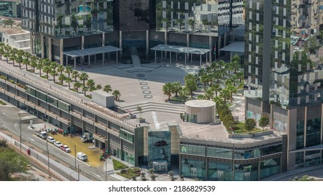 Rooftop Garden With Palms Near Entrance To Office Towers In Financial District Of Dubai City Morning Timelapse. Aerial View With Road And Parking