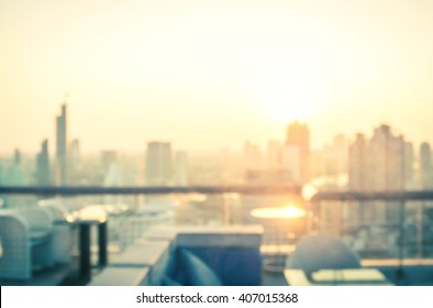 Rooftop party concept: Blurred dining table restaurant with beautiful city view at twilight scene background. Bangkok, Thailand, Asia