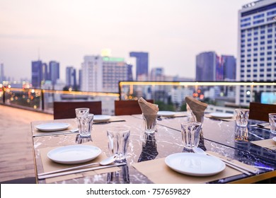 Rooftop Romantic Dinner Set With Cityscape View.