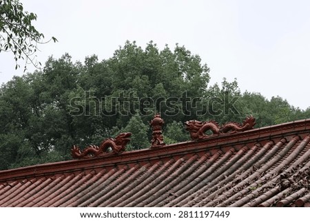 Rooftop with sculpture of Two Dragons Playing with a Pearl at Oriental Buddha Park, Leshan, Sichuan Province of China