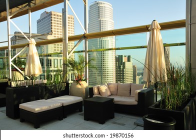 Rooftop Seating Area With A Skyscraper Sunset View