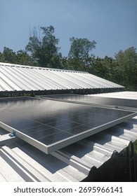 Rooftop solar panel installation on a metal roof. Harnessing clean energy under clear skies. Ideal for residential or agricultural power solutions. Get your solar system today! #SolarEnergy #Renewable
