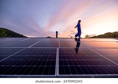 Rooftop with solar panels on house in mountains, woman walks alone enjoying sunset. Energy independence, sustainability, self sufficient, and escapism to nature concept - Powered by Shutterstock