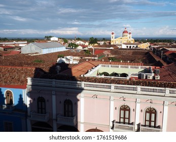 Rooftop view from the bell tower of the Iglesia La Merced in central Granada, Nicaragua. Facing east, towards Cathedral of Granada and the lake. Shadow of the bell tower visible. Beautiful sky.