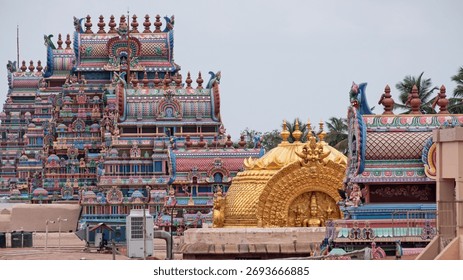 Rooftop view of part of the temple complex dedicated to Ranganatha, an avatar of Vishnu, at Trichy which is the largest such Hindu compound in India. The golden roof caps the inner sanctum, or Vimana