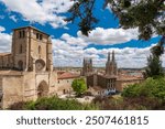 Rooftops of Burgos city. View of Burgos Cathedral and historic city center. Spectacular Cathedral baroque architecture. Cloudy day. Famous travel destination in Spain.  Panoramic city center view.