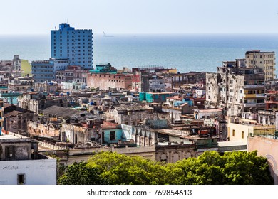 The rooftops of Havana occupy the frames foreground as boats head into Florida Straits.