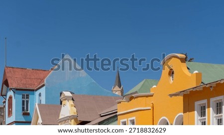 Rooftops of painted Ladies of Lüderitz, Namibia on Bergstraße. Colorful,  German Art Nouveau (Jugendstil) colonial homes and buildings from diamond rush. Built in 1909 and 1910. Haus Eberlanz, Haus Grünewald, Felsenkirche.
