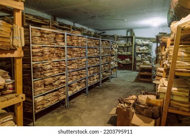 Room of an abandoned soviet administrative building with old archival paper documents on racks in piles - Shutterstock ID 2203795911