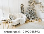 Room with Christmas decorations, white sofa adorned with lights, cozy blanket, Christmas tree decorated with ornaments, gold gift boxes, staircase, elegant and festive