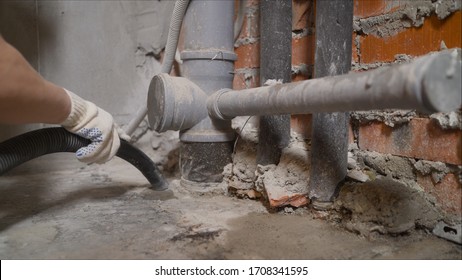 Room Cleaning With An Industrial Vacuum Cleaner. Man Vacuuming A Construction Site