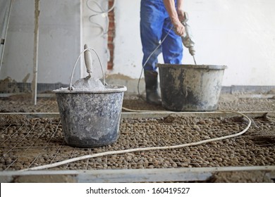 Room With Expanded Clay Aggregate On The Floor And Worker With Tool