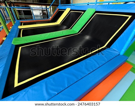 A room filled with an array of vibrant trampolines