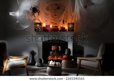 Room with fireplace decorated for Halloween. Festive interior