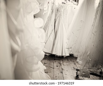 A Room Full Of White Wedding Dresses And Veils.