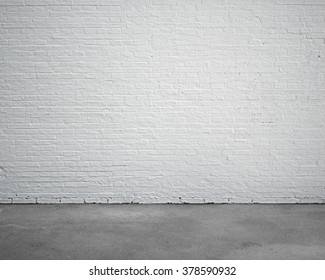 room interior with white brick wall and concrete floor, nobody, empty