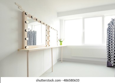 Room with makeup mirror lights and window