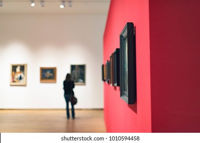 Room in museum with artworks and visitor. - Shutterstock ID 1010594458