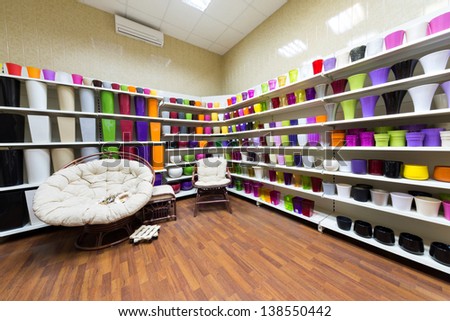 Room with shelves full of varicolored flowerpot