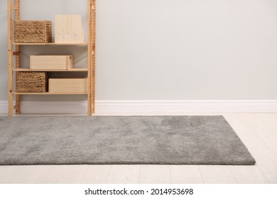 Room With Soft Grey Carpet, Shelving Rack And Light Wall. Space For Text