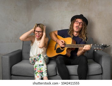 Roommate Playing Loud Music On Guitar Disturbing And Annoying Friend