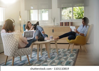 Roommates Talking Together In Living-room