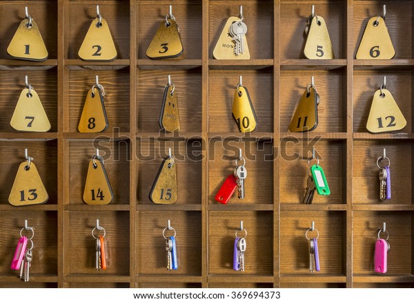 Rooms\
keys at a two stars hostel reception desk\
counter.