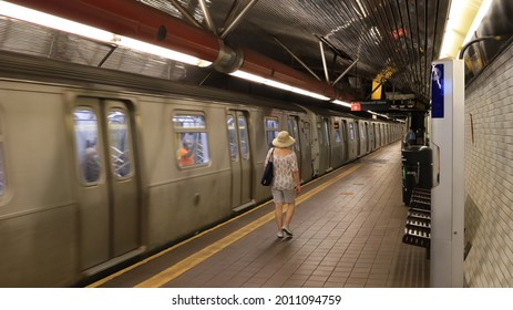 Roosevelt Island, NY, USA - July 19, 2021: The F-train Subway Leaving The Roosevelt Island Station