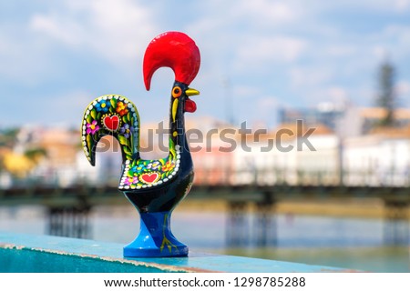 Rooster of Barcelos (Galo de Barcelos) on a quay of river Gilao. Tavira, Algarve, Portugal