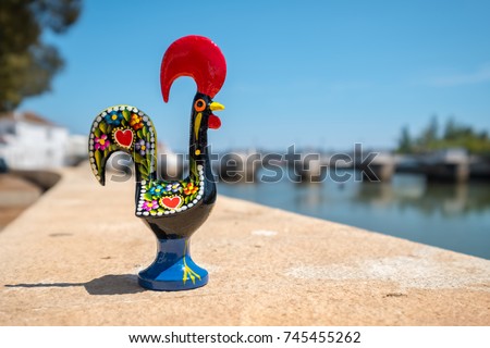 Rooster of Barcelos (Galo de Barcelos) on a quay of river Gilao. Tavira, Algarve, Portugal