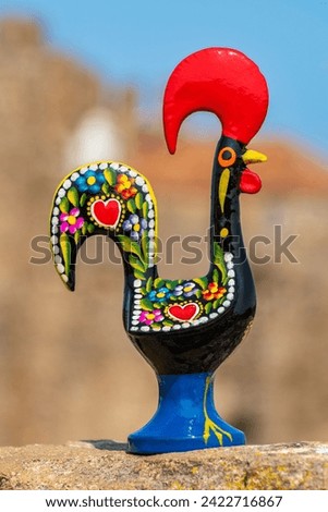 Rooster of Barcelos (Galo de Barcelos) stands on a medieval wall. Obidos, Portugal
