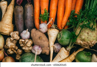 Root crops, carrots, parsley root, turnip, onion, garlic, Jerusalem artichoke, horseradish. Root crops background. Food background - Shutterstock ID 650620165