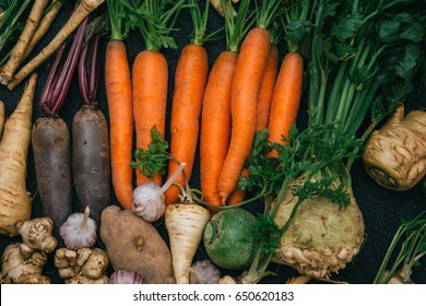 Root crops, carrots, parsley root, turnip, onion, garlic, Jerusalem artichoke, horseradish. Root crops background. Food background - Shutterstock ID 650620183