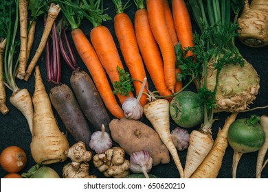Root crops, carrots, parsley root, turnip, onion, garlic, Jerusalem artichoke, horseradish. Root crops background. Food background - Shutterstock ID 650620210