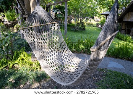 Rop Hammock Hanging On Tree For Relaxing In The Public Garden And Café garden.