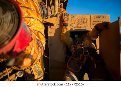 Rope Access Construction Worker Wearing Safety Harness Entering Restricted Dangerous Area Manhole Working In Confined Space Perth, Australia