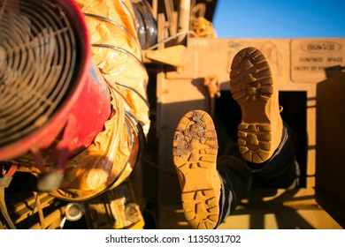 Rope Access Miner Wearing Safety Boot Harness, Helmet Entering Into Confined Space Manhole Door Construction Mine Site Perth, Australia 
