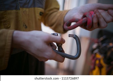 Rope access miner worker clipping industrial carabiner 10.5 MM dynamic rope low elongation into barrel knot cow-tail safety back up construction building site Perth, Australia 