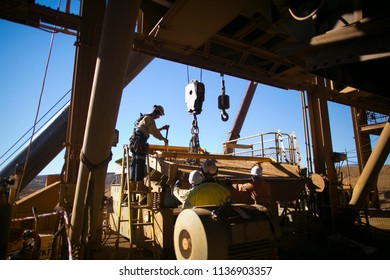 Rope Access Rigger Wearing A Fall Safety Protection Helmet Harness Is Standing On Safety Ladder Rigging Inspection Crane Lifting Sling Before Commencing Task Construction Site Perth, Australia   
