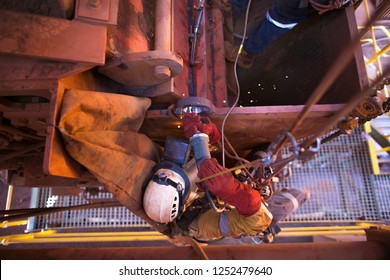 Rope Access Welder Hanging On Rope Working At Height In Fall Arrest Position Performing Using Die Grinder To Finishing Cleaning Preparation Off Crane Lifting Lug Construction Site Sydney, Australia