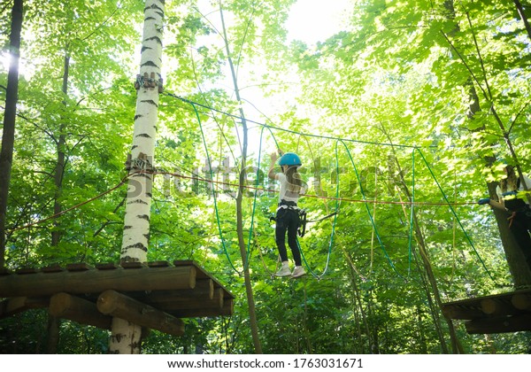 Rope\
adventure - a little girl walking on a rope\
bridge