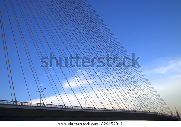 A rope bridge in\
Bangkok city and blue sky