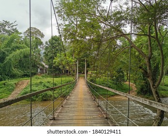 Rope Bridge Built Over The Stream So That People Can Use It To Walk Across To The Other Side