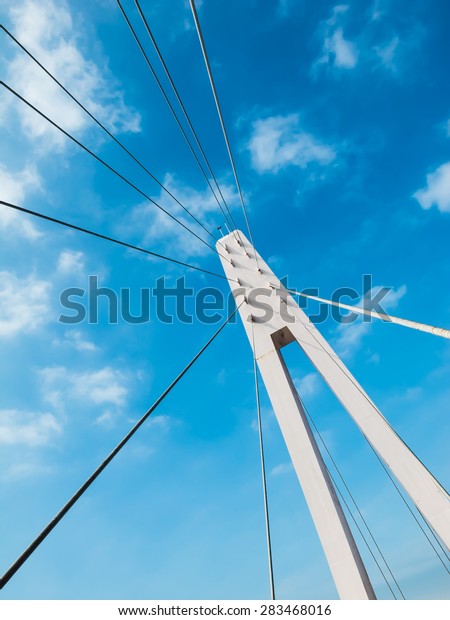 Rope bridge and\
cable sling of bridge. Rope bridge with blue sky. Architecture\
abstract with rope bridge.