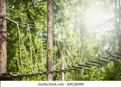 Rope Bridge In Climbing Forest Or High Wire Park On Nature Sunny Background