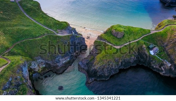 The rope bridge connecting the two cliffs in\
Northern Ireland it is called the Carrick-a-Rede Rope Bridge taken\
in an aerial shot