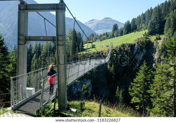rope bridge\
over a deep canyon, tirol,\
austria